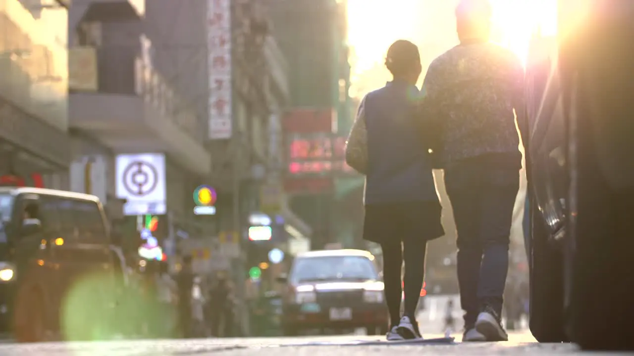 Pedestrians Crossing Road at Sunset