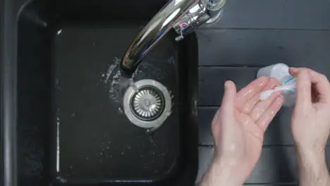 Top Down Shot of Male Hands Washing Hands with Soap