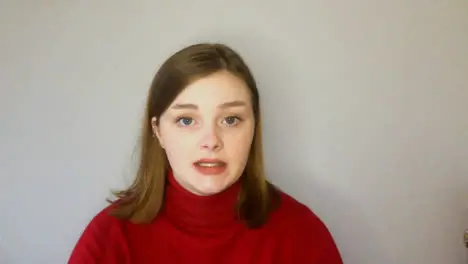 Female Young Student Presenting and Talking Directly into Camera