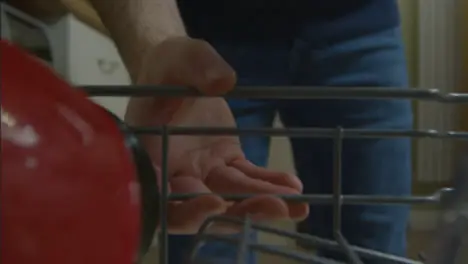 POV Shot of Male Opening Dishwasher Drawer and Placing Mug In It