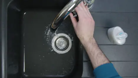 Top Down Shot of Male Hands Washing Under Running Tap