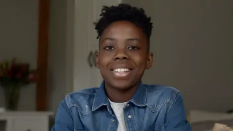 Young Boy Smiling and Talking into Webcam During Video Call