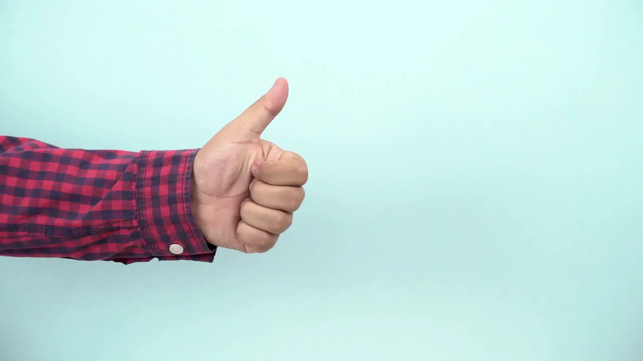 person thumbs up on blue background