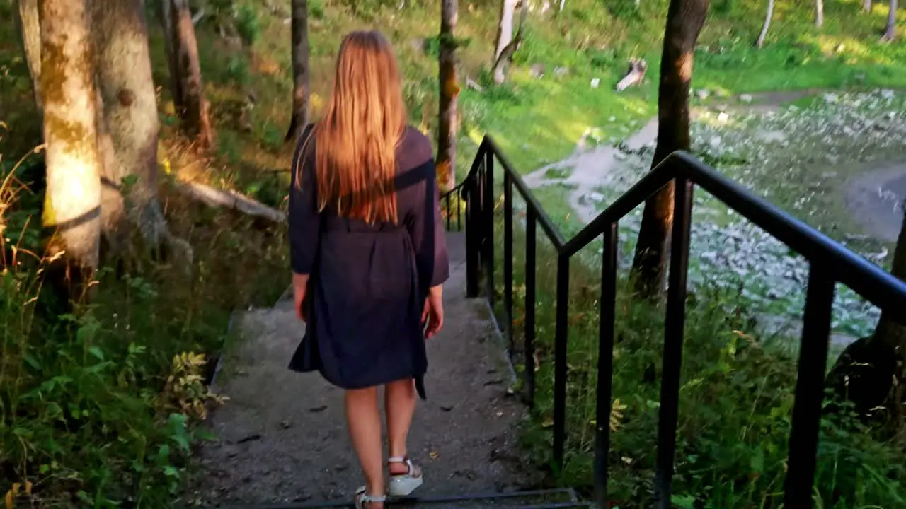 Adventurous tourist lady sightseeing the location of Kaali crater in Estonia