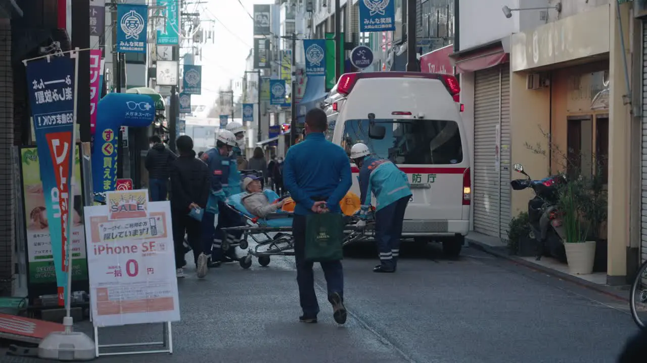 First Aid Responders From Tokyo Fire Department Carrying A Patient On Stretcher Onto The Ambulance On New Year Day In Street Of Tokyo Japan