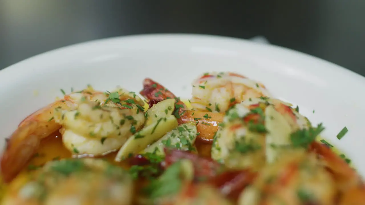 Close up of Mediterranean shrimp soup with green Parsley plate health seafood keto diet