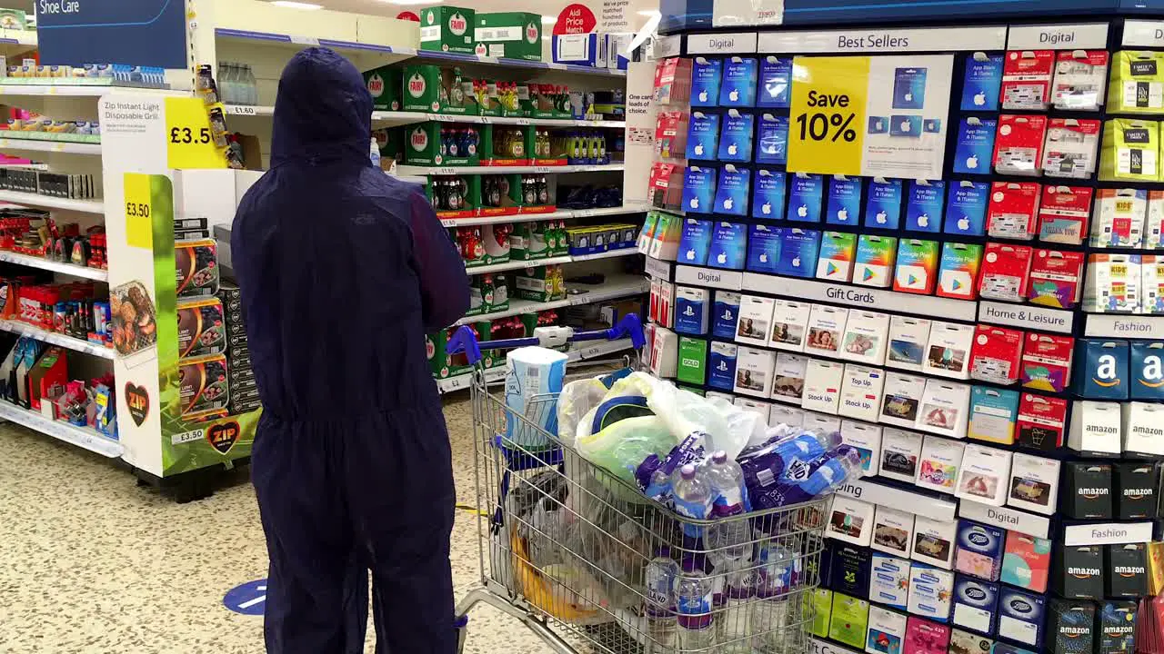 Shopper in full Hazmat suit in Tescos supermarket Whitstable Kent UL