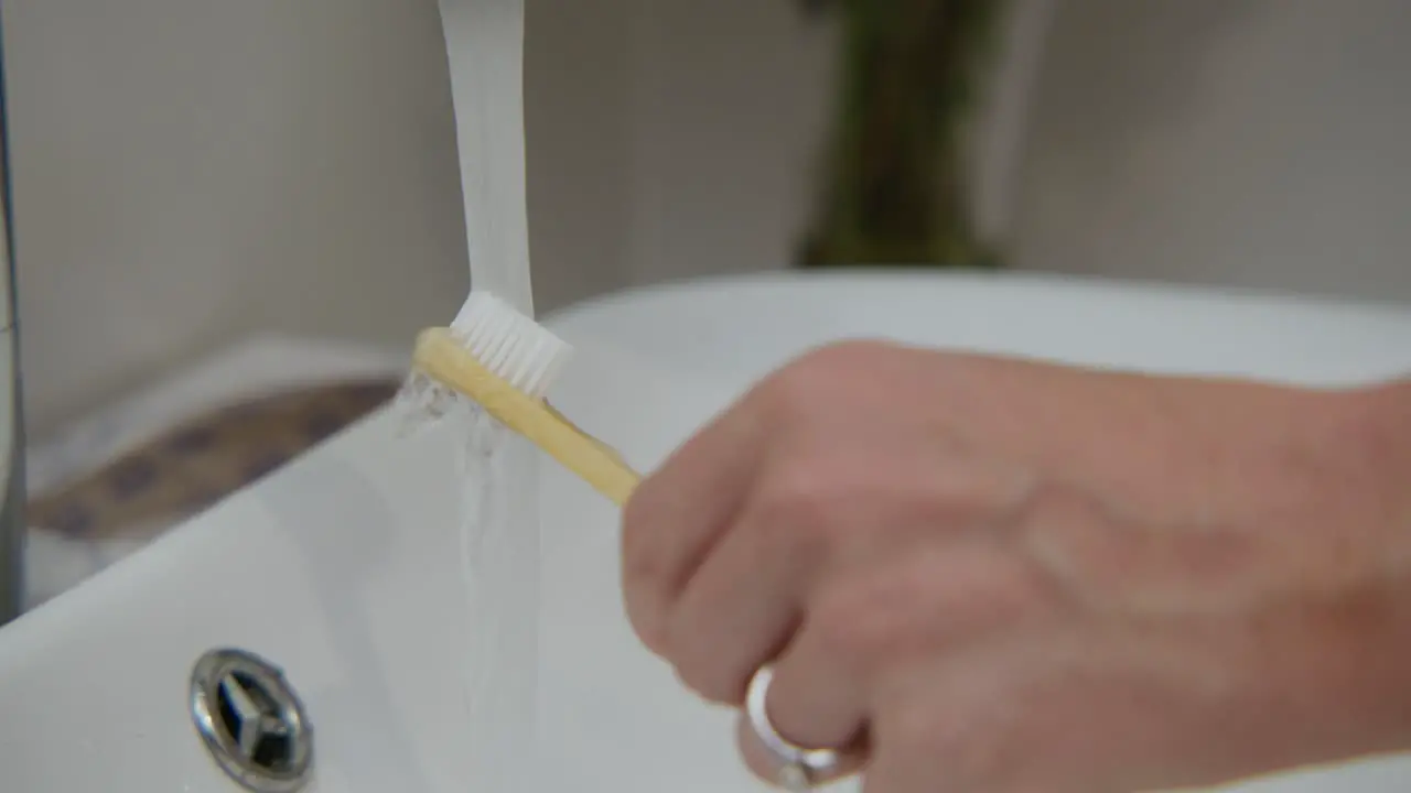 A woman washing tooth brush close up