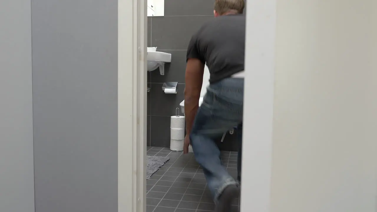 Man running to toilet and vomit