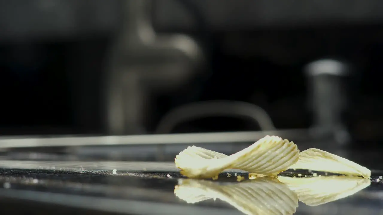 Potato chip falling onto counter in kitchen