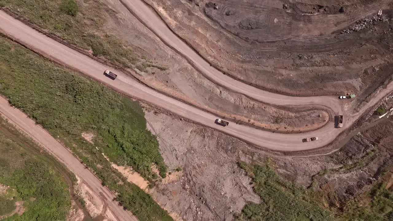 Overhead Drone View of Trucks Hauling Dirt Away From Siana Glod and Silver mine Mainit Philippines