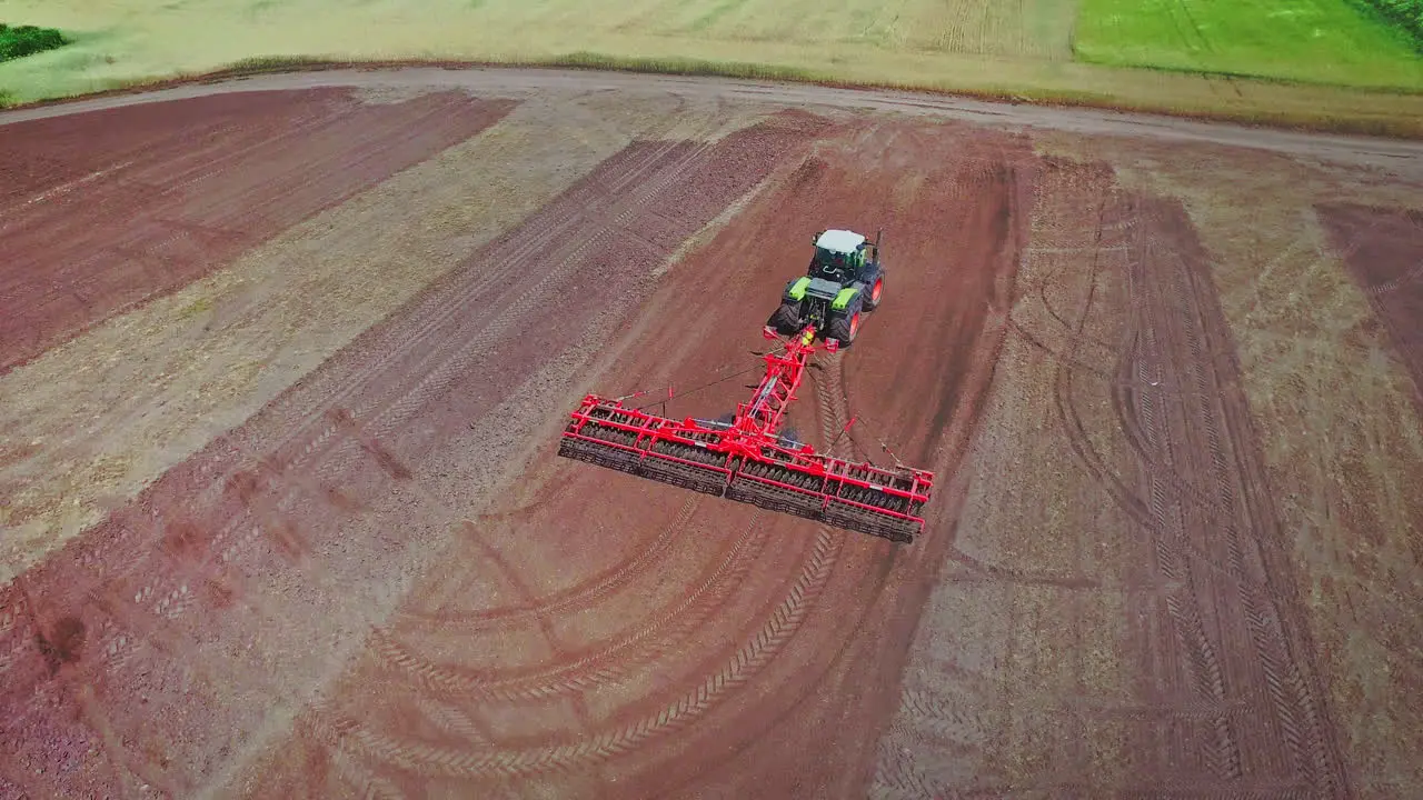 Farming tractor with trailer plowing on ploughing field Rural farming