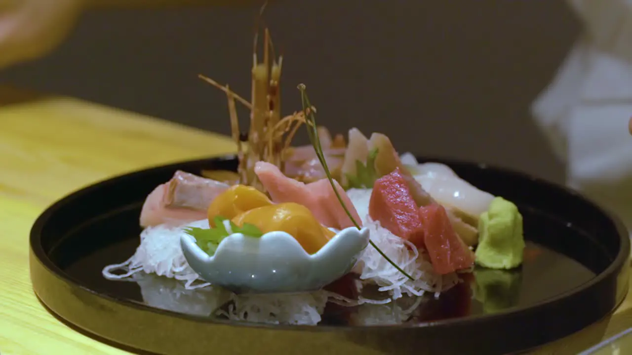 Chef Decorating Chinese Food In A Tray Before Serving close up