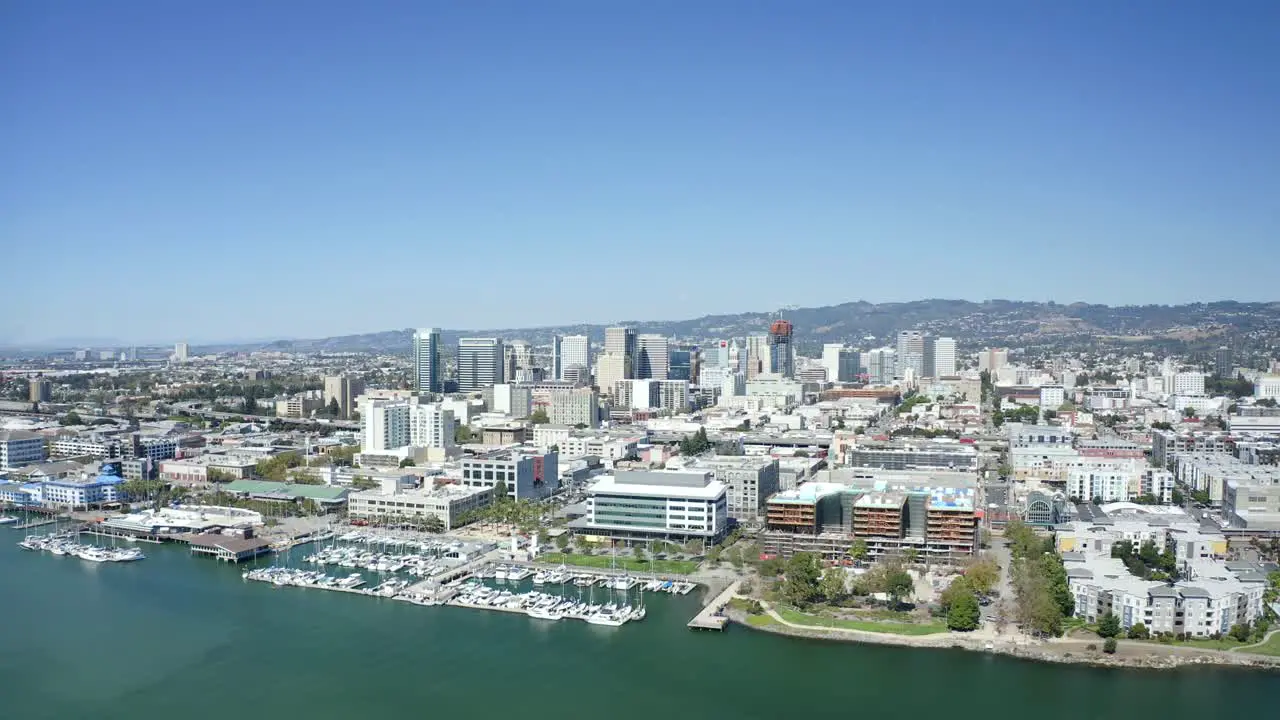 A beautiful sunny day as the camera passes over the city with bright buildings and a clear blue sky