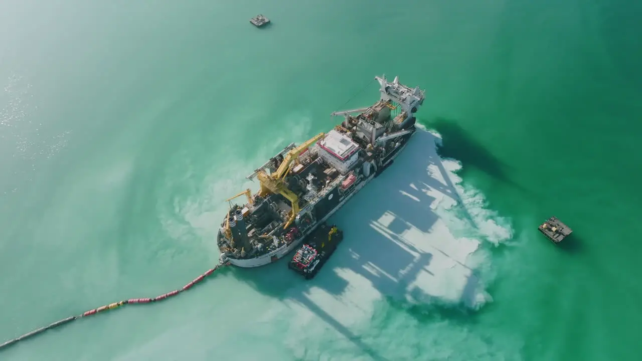 Aerial footage rotating around a giant sand dredging ship in the harbor outside of Bari Italy in the Adriatic Sea