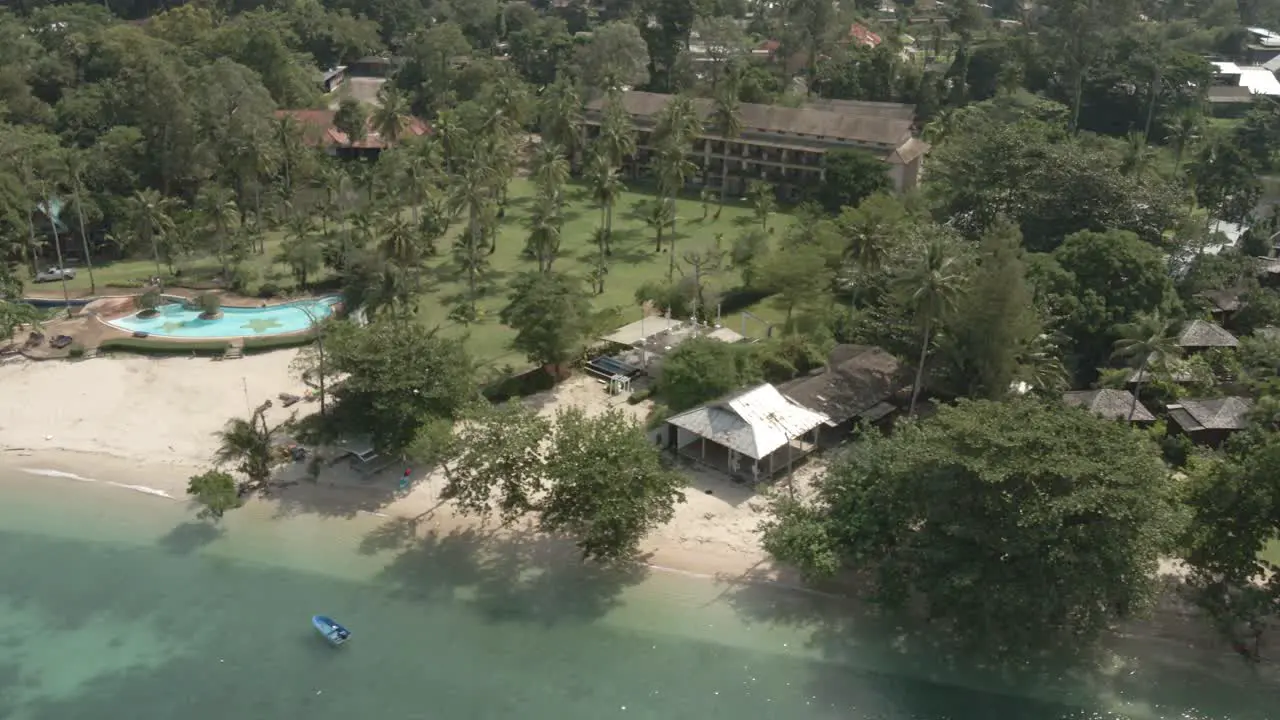 Aerial drone shot of a empty deserted tropical beach tourist resort in Thailand with no tourists due to travel restrictions and shut downs with empty hotels and empty beaches