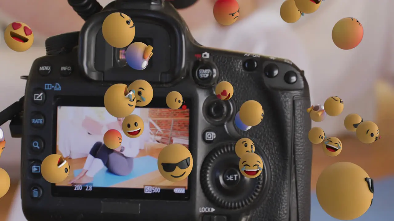 Animation of emojis over camera viewer with female fitness vlogger exercising at home