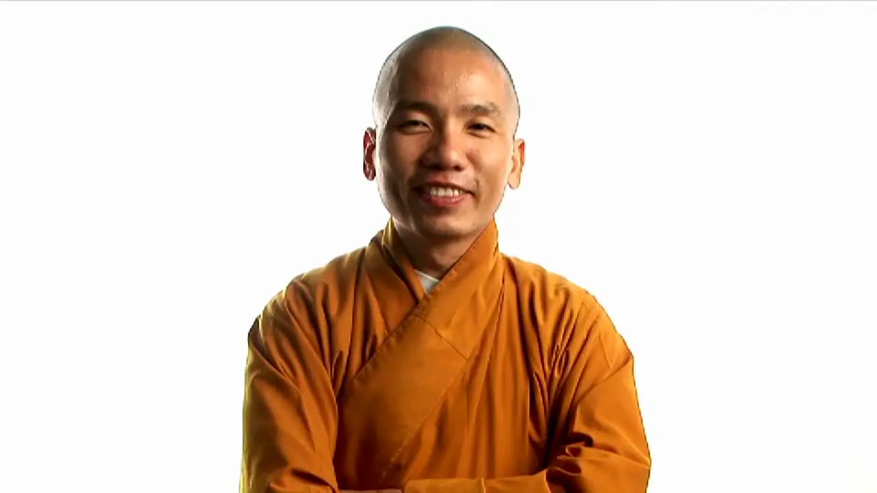 A Buddhist monk wearing an orange robe 1