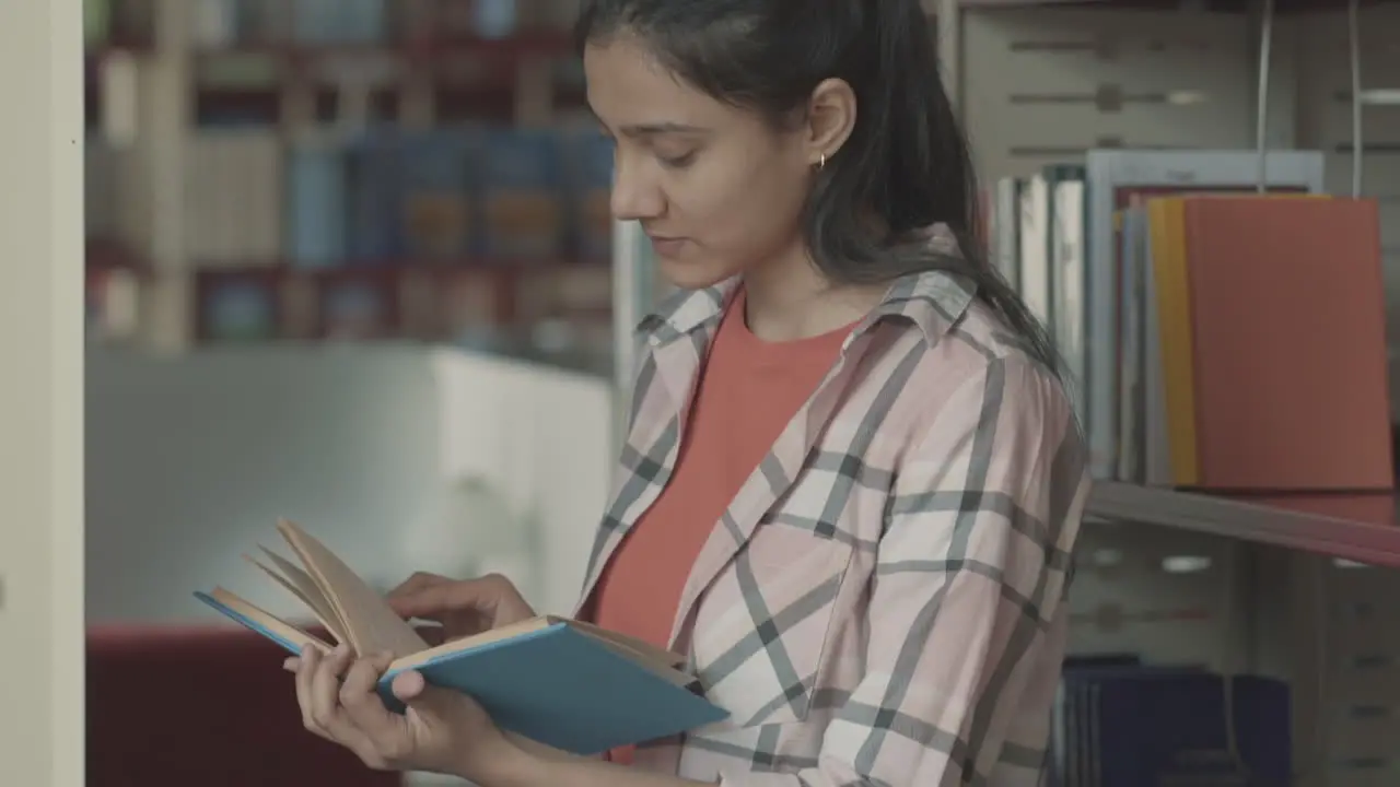 Pretty Girl Reading A Book In The Library