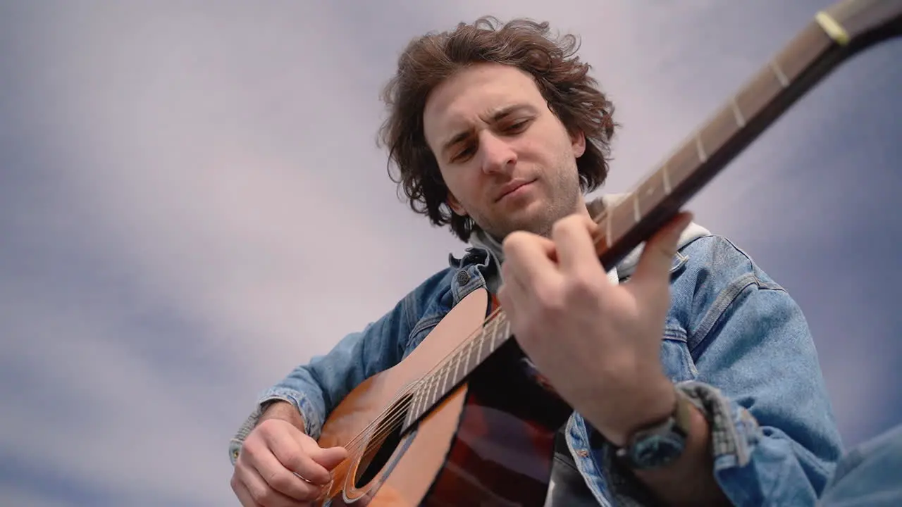 A Young Boy Plays The Guitar