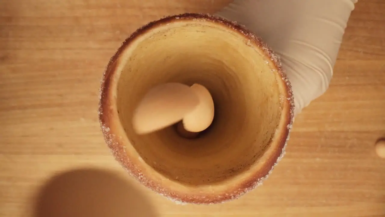 Biscuits being dropped inside the cone of spit cake top-down cinematic slowmo