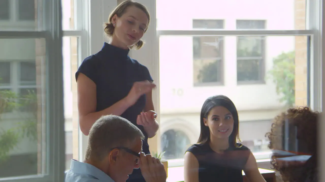 Businesspeople Meet In Boardroom Through Glass Shot On R3D