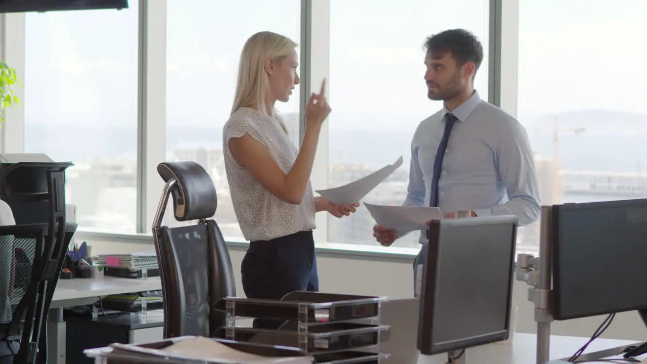 Businesspeople Working At Office Desk On Computer Together