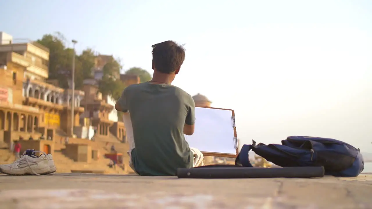 Reveal Shot of a Man Drawing in Varanasi