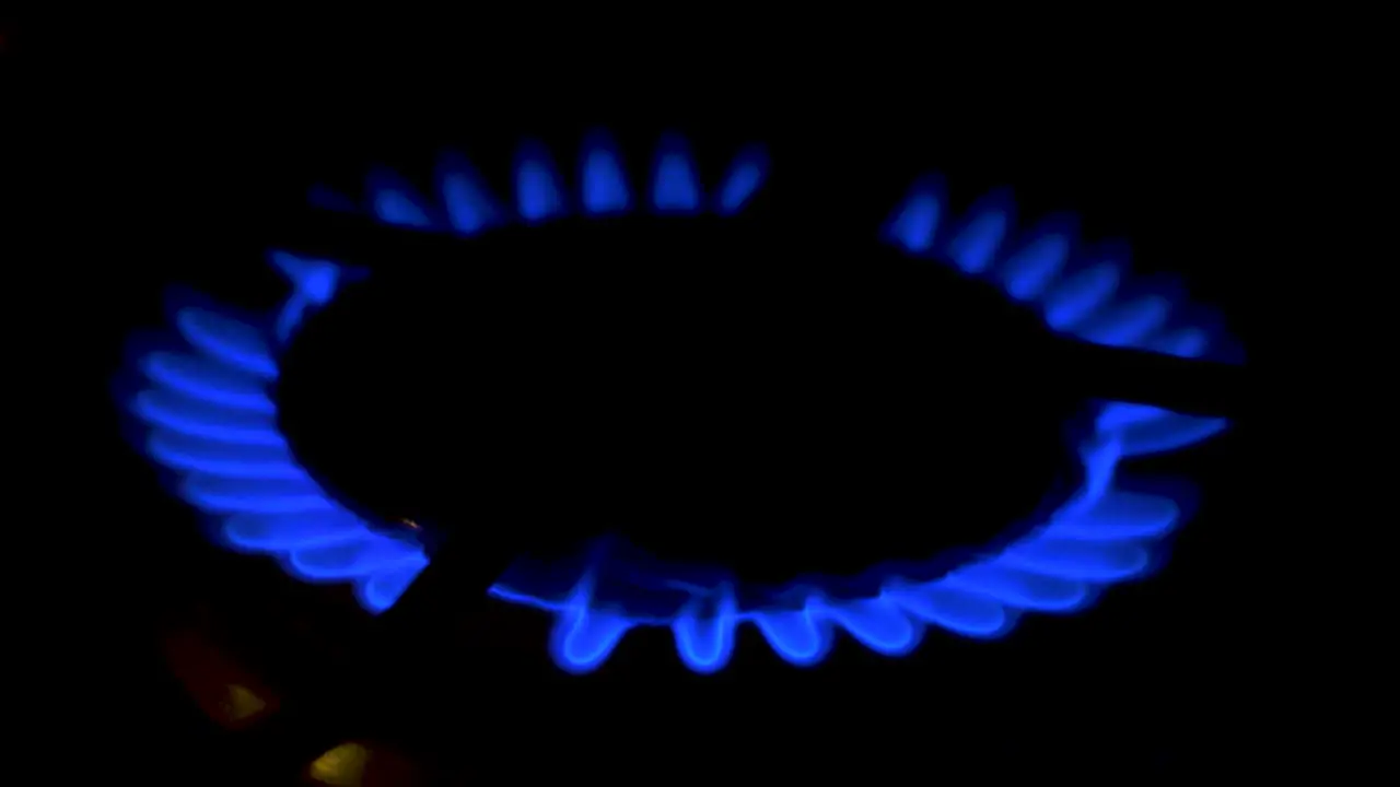 Gas burning from a kitchen gas stove dark background cold winter and energy crisis concept closeup shot