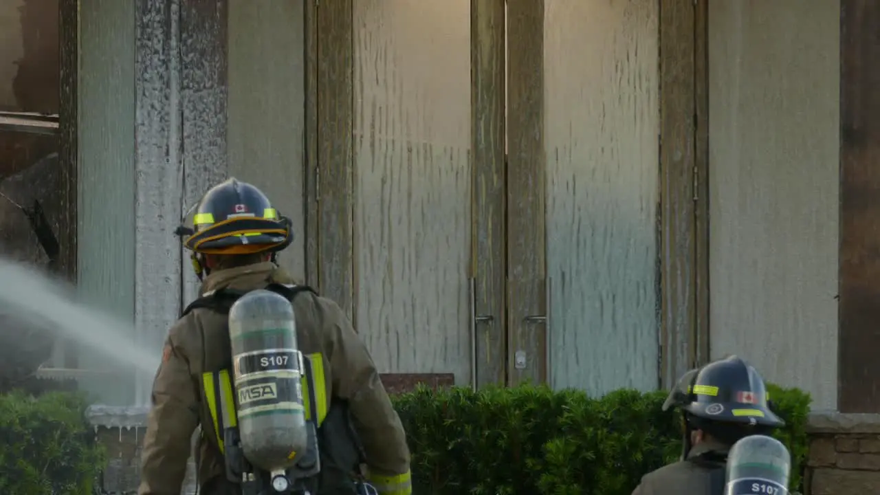 firefighters pumping off foam in a fire-affected place to extinguish the flames