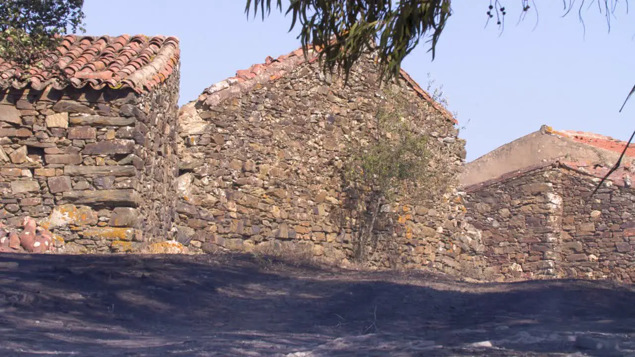 The blackened still smoking ground next to the mountain houses after a forest fire