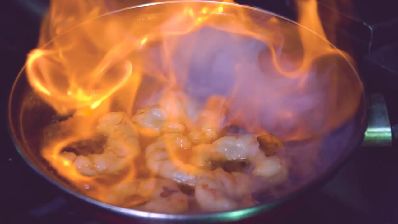 Cooking flambe shrimps in pan