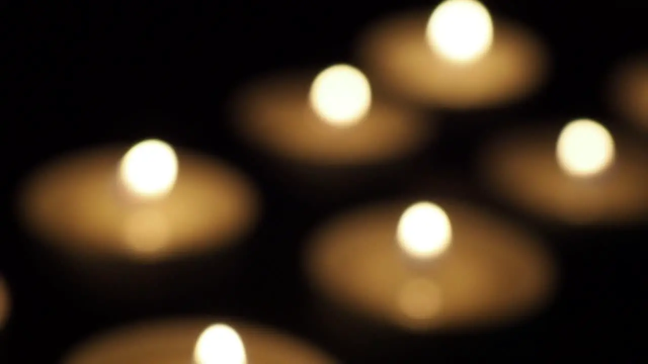 Candles in the dark out of focus slide dolly