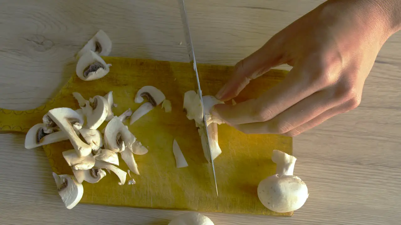 Woman cutting mushrooms in slow motion