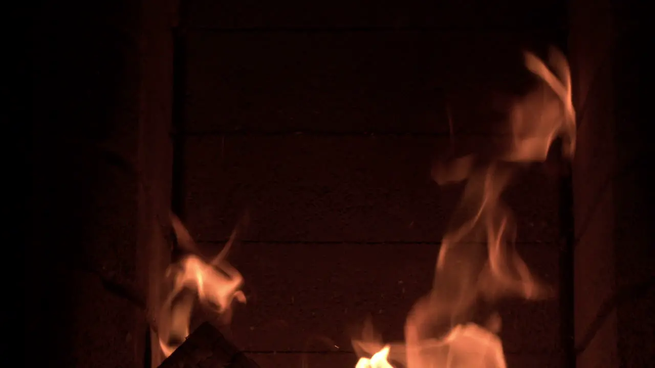 Fire roaring in a fireplace dolly shot