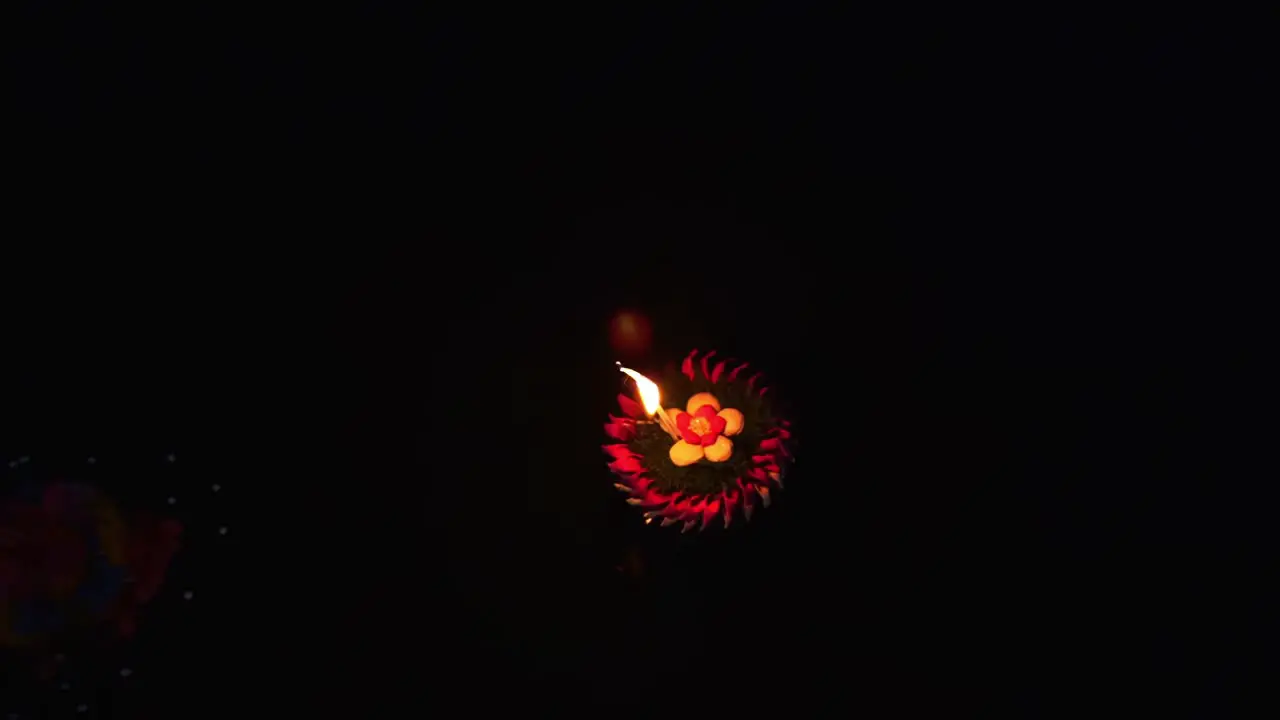 Loy Krathong Festival Top down view of Colorful Krathong floating on the dark blue water on the lake