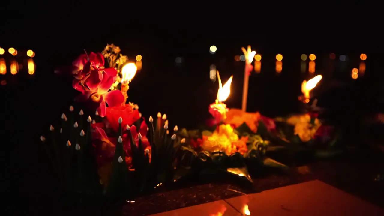 Loy Krathong Festival Close-up shot of Colorful Krathongs with a burning candles and incense on top