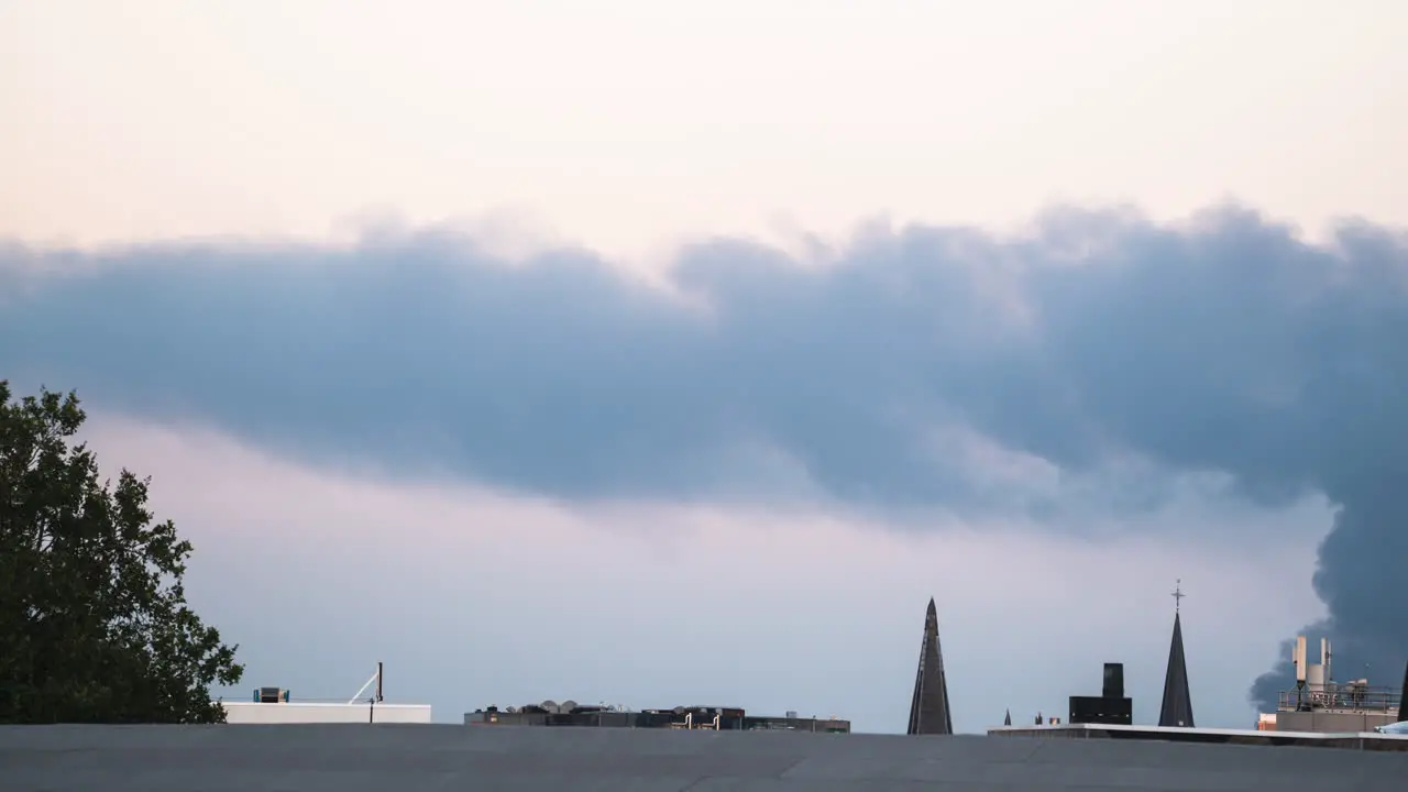 Timelapse of a smoke column rolling over the roof of Antwerp Belgium