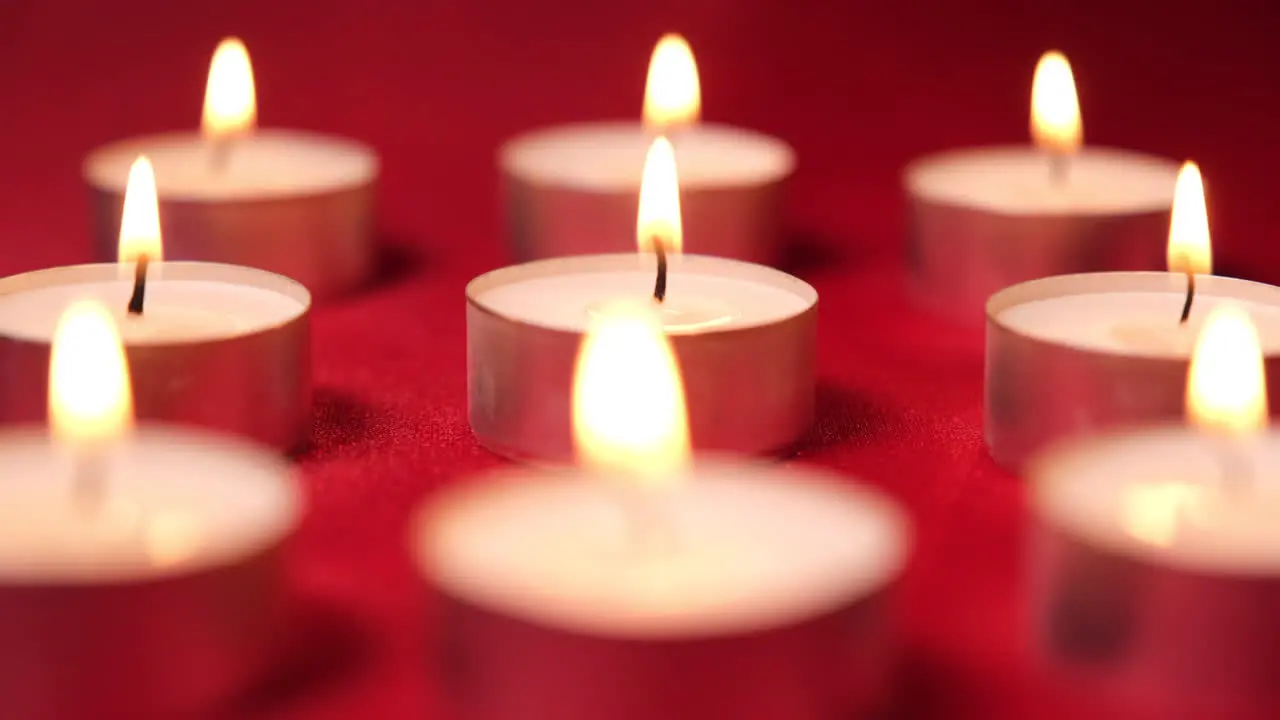 Candles for Christmas celebration on red background