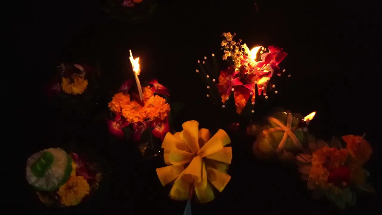 Loy Krathong Festival Top-down Close-up shot of Colorful Krathongs floating on the water