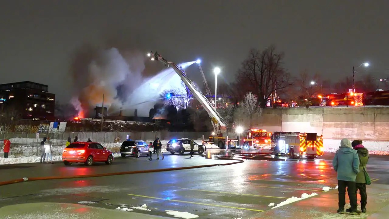 Huge house fire in Toronto being fought by firefighters spraying water from aerial ladder