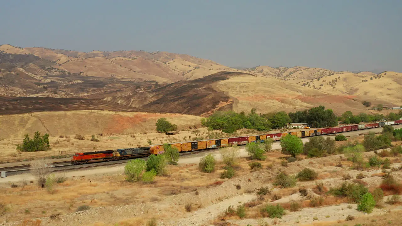 The Union Pacific train passes by landscape scorched by wildfires near Caliente California aerial view