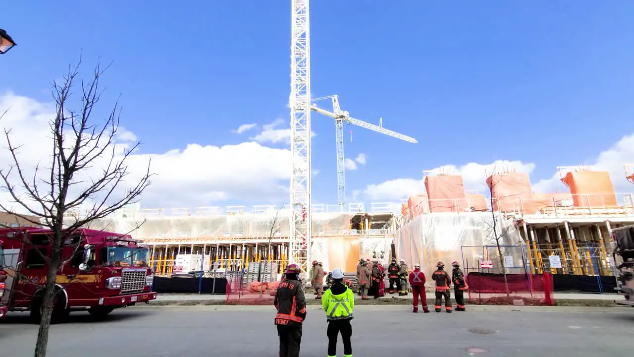 Fire Fighters standing outside of a construction site rotating shot