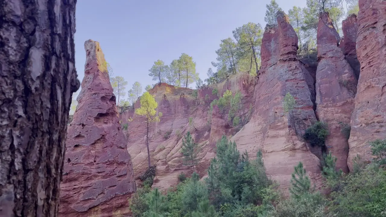 Exciting rock pillar in nature with colored rocks in the background and some trees