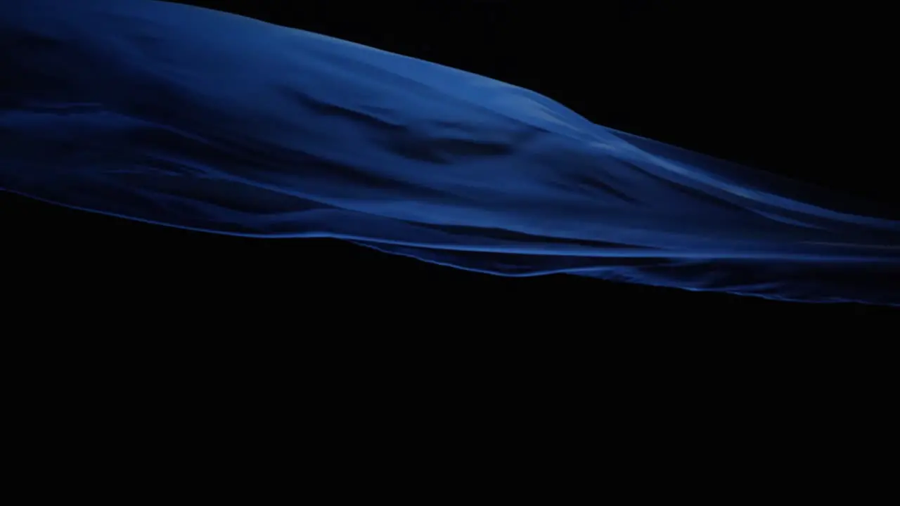 Blue Silk Cloth Flying In Black Background studio shot