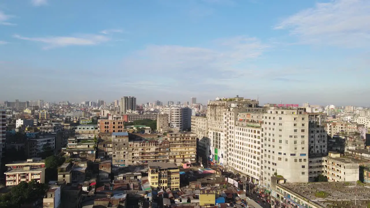 Aerial view shot of Dhaka packed buildings with camera moving up in the air