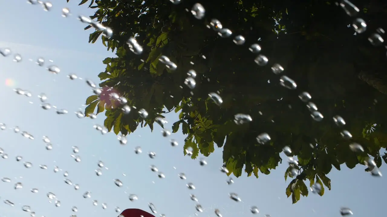 Water fountain in slow motion in a camping tree in background