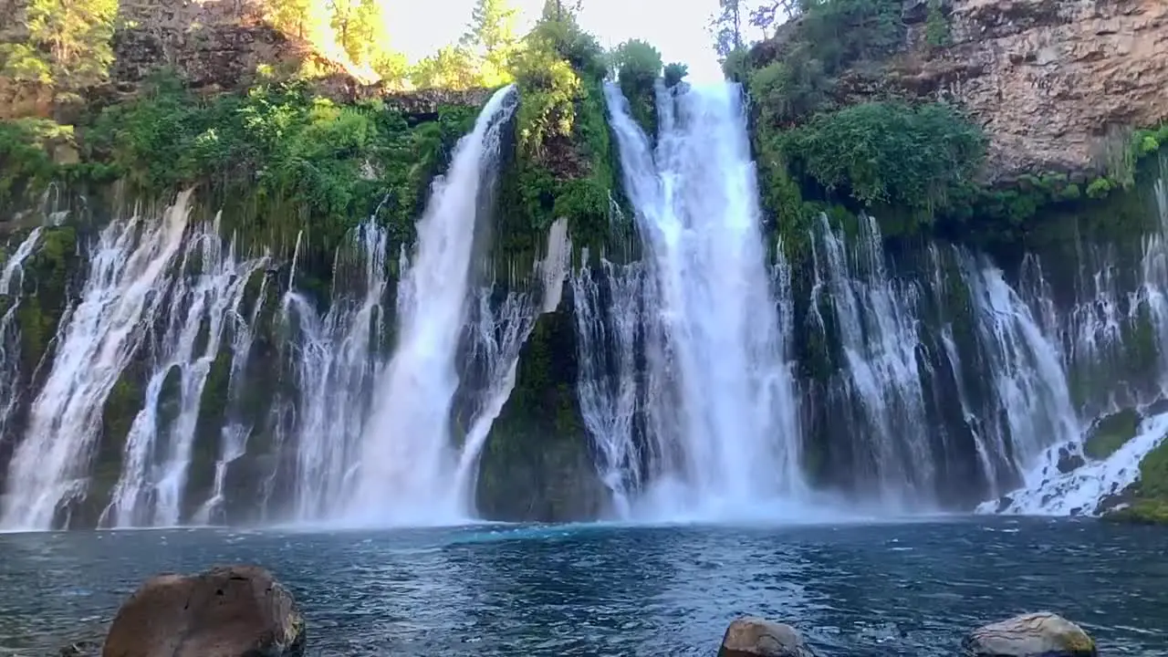 A slow motion video of Burney Falls gracefully but powerfully cascading down volcanic rocks causing a refreshing mist below