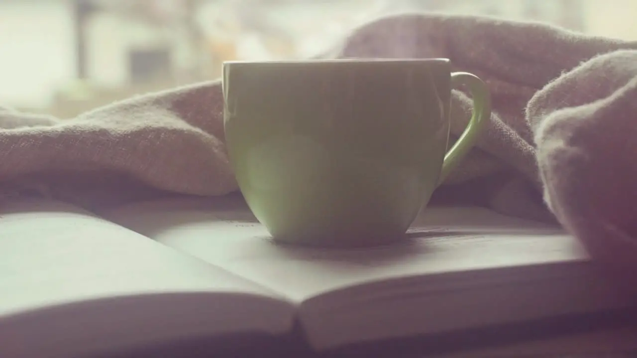 Concept of relaxation during a Sunday morning at the weekend in the background of a cup of coffee and a good book to relax