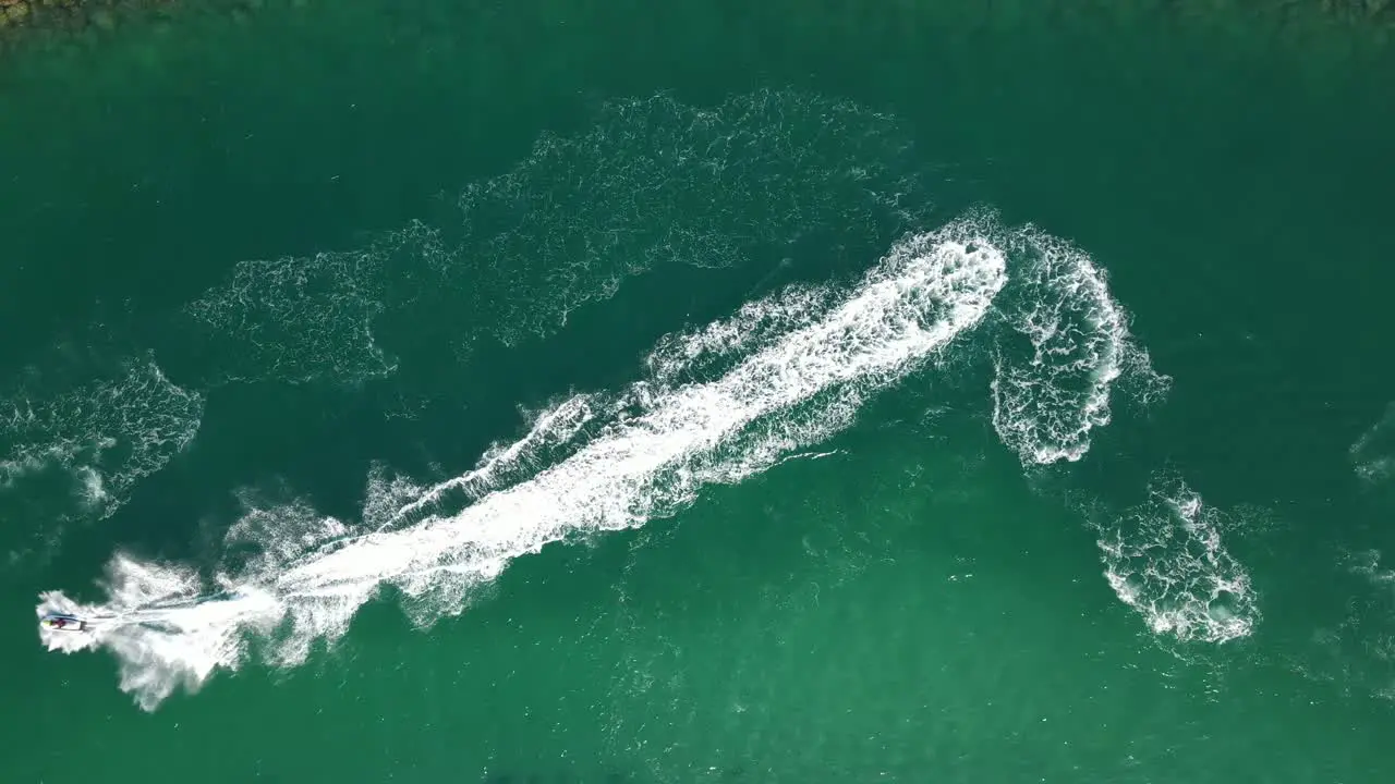 Top view of jet-skiing in blue-green crystal clear water of Dubai's Mamzar beach Arabian Sea top tourist attraction UAE 4k Footage